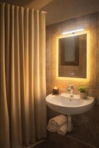 a bathroom with a sink and a shower curtain at Angelparadise village stefani in Stefáni +12 photos