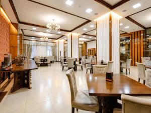a dining room with tables and chairs and a restaurant at Cathedral Plaza Hotel in Gyumri