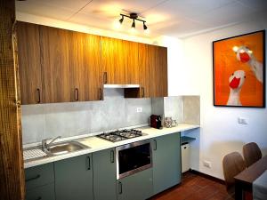 a kitchen with a sink and a stove top oven at Appartamento Lucia in Ampezzo