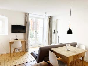 a living room with a couch and a table at Haus Münsterblick in Reichenau