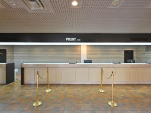 an empty waiting room with a front counter in an airport at Livemax Resort Hakodate Shikabe Onsen in Shikabe +102 photos