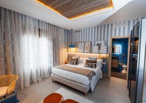 a bedroom with a bed in a room with blue stripes at Nomada House by SH Hoteles in Denia +30 photos