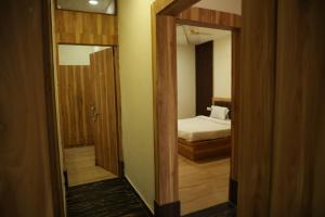 a doorway to a bedroom with a bed and a mirror at Shiv Resort & Palace in Shivpurī