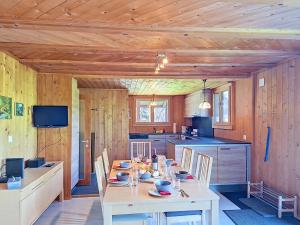 a kitchen with a table with chairs and a tableablish at Chalet Egg-Isch by Interhome in Grindelwald