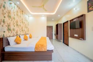 a bedroom with a bed and a tv on a wall at Hotel Neel Kamal-Near KhatuShyamJi Temple in Khātu
