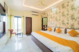 a hotel room with a bed and a tv at Hotel Neel Kamal-Near KhatuShyamJi Temple in Khātu