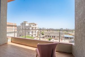 a balcony with a chair and a view of a city at Hotel Neel Kamal-Near KhatuShyamJi Temple in Khātu