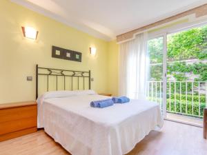 a bedroom with a bed and a large window at Apartment Buenos Aires by Interhome in Lloret de Mar