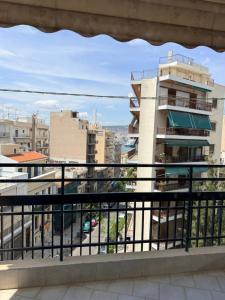 a view of a city from a balcony at Piraeus new hotel in Piraeus