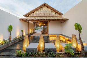 a lobby of a resort with two benches and a building at Solaris Villa Bali in Kuta