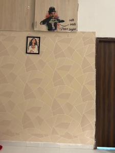 a wall with a picture on top of it at Kesarionstay in Indore +4 photos