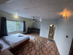 a bedroom with a bed and a room with a window at Tranquility Apartment in Pokhara