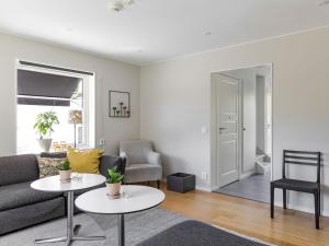 a living room with a couch and two tables at Villa Villa Anja by Interhome in Asarum