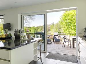 a kitchen with a sliding glass door leading to a deck at Villa Villa Anja by Interhome in Asarum +14 photos