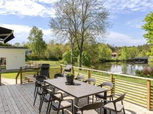 a patio with a table and chairs and a river at Villa Villa Anja by Interhome in Asarum
