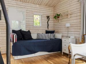 a bedroom with a bed and a window at Holiday Home Ringenäs by Interhome in Halmstad