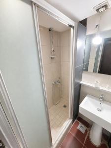 a bathroom with a shower and a sink at The Square Central Prishtina in Prishtinë