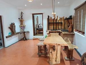 a room with a wooden table and a mirror at The Wood Cottage in Elkaduwa +7 photos