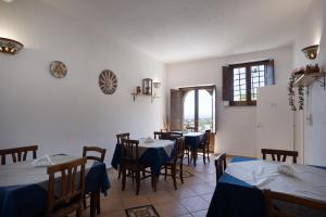 a dining room with tables and chairs and a window at La Locanda degli Amici in Santa Teresa di Riva