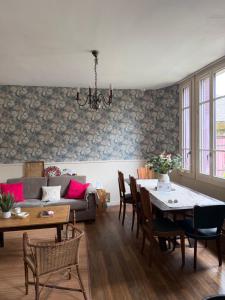 a living room with a couch and a table at Maison Bécharie in Uzerche