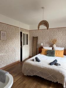 a bedroom with a large bed and a bath tub at Maison Bécharie in Uzerche