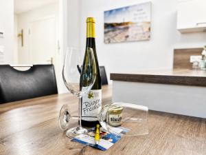 a bottle of wine sitting on a table with a wine glass at Ferienwohnung Meeresblick Haus Granitz in Prora in Binz +11 photos