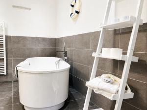 a bathroom with a white toilet and a shelf at Ferienwohnung Meeresblick Haus Granitz in Prora in Binz