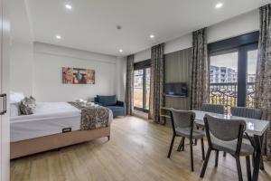 a bedroom with a bed and a table and chairs at Daylights Apart Otel in Antalya +39 photos
