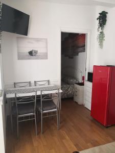 a kitchen with a table and chairs and a red refrigerator at Il mare ad un passo in Varazze +10 photos