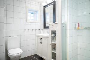 a white bathroom with a toilet and a sink at Budalen, spacious cabin close to skitracks in Holo +52 photos
