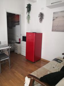 a red refrigerator in a room with a table at Il mare ad un passo in Varazze