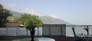 a balcony with a table and a view of the water at Adarsh villa in Dharmsāla