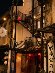 a building with a staircase and a building with lights at Astrid Lofts in Ipoh