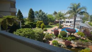a view of a garden from the balcony of a house at Hotel Spa Bosque Mar in Reboredo