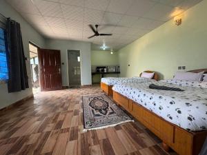 a bedroom with two beds and a ceiling fan at Tranquility Apartment in Pokhara