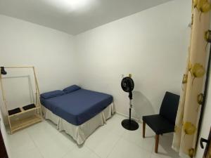 a bedroom with a bed and a mirror and a chair at Apartamento no Crato, conforto e praticidade! in Crato