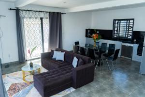 a living room with a couch and a table at Résidence Vahi-Ni, Villa Faniry in Hell-Ville