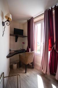 a room with a desk and a window with red curtains at Beauséjour in Calvinet