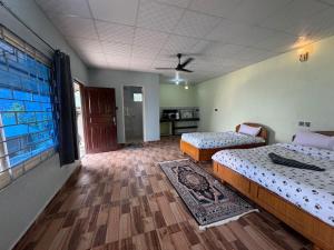 a room with two beds and a kitchen at Tranquility Apartment in Pokhara +2 photos