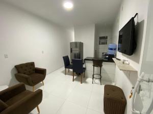a living room with a couch and chairs and a tv at Apartamento no Crato, conforto e praticidade! in Crato