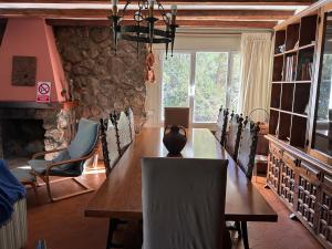 a dining room with a long wooden table and chairs at Villa Karina in Valdemanco