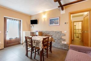 a dining room with a table and a stone wall at La Baita - Bionaz in Bionaz
