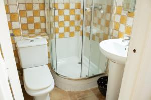 a bathroom with a shower and a toilet and a sink at Magdalena2 Street, Private rooms in Madrid +34 photos