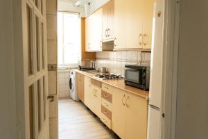 a kitchen with a microwave and a stove top oven at Magdalena2 Street, Private rooms in Madrid