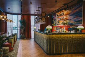 a bar in a restaurant with a yellow counter at Salthouse Harbour Hotel and Spa in Ipswich