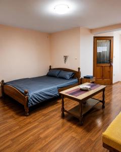 a bedroom with a bed and a coffee table at Native Apartments in Budva