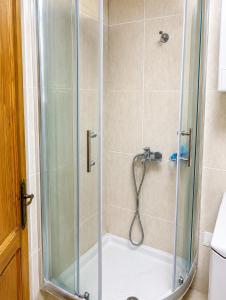 a bathroom with a shower with a glass door at Native Apartments in Budva +16 photos