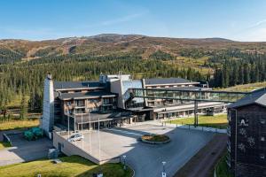 an aerial view of a building with mountains in the background at Skistar Lodge Trysil in Trysil