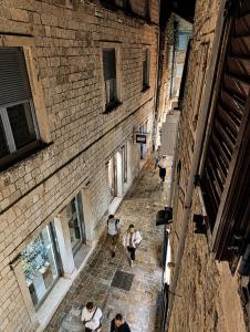 a group of people walking down an alley at Native Apartments in Budva
