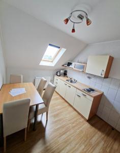 a kitchen with a table and chairs and a kitchen with a sink at Guest House Matej & Mateja in Plitvička Jezera